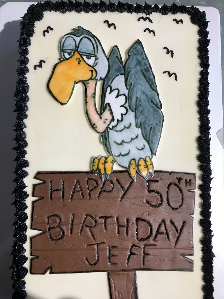 a birthday cake with an image of a bird holding a sign that says happy 50th birthday jef