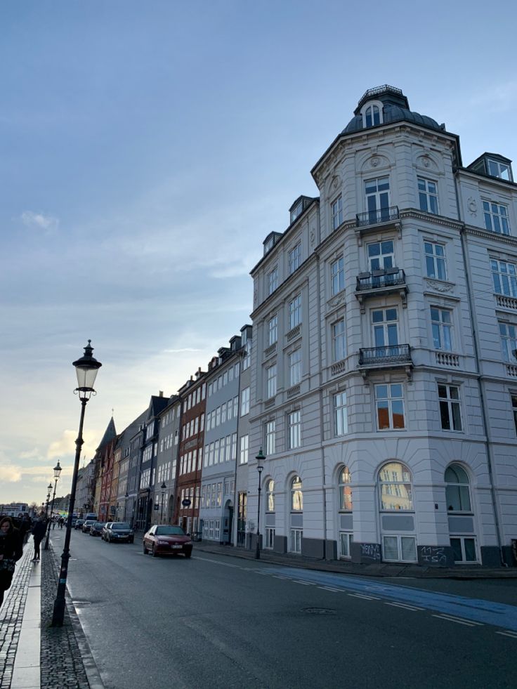 an empty street with cars parked on the side