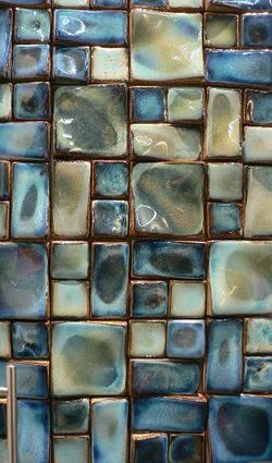 a close up view of blue and green tiles