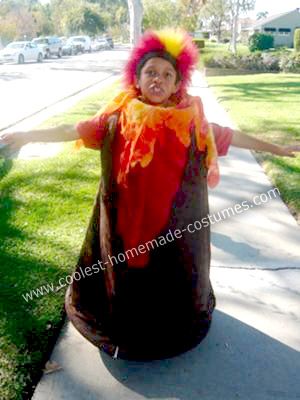 a child dressed up in a costume on the sidewalk with his arms out and hands outstretched