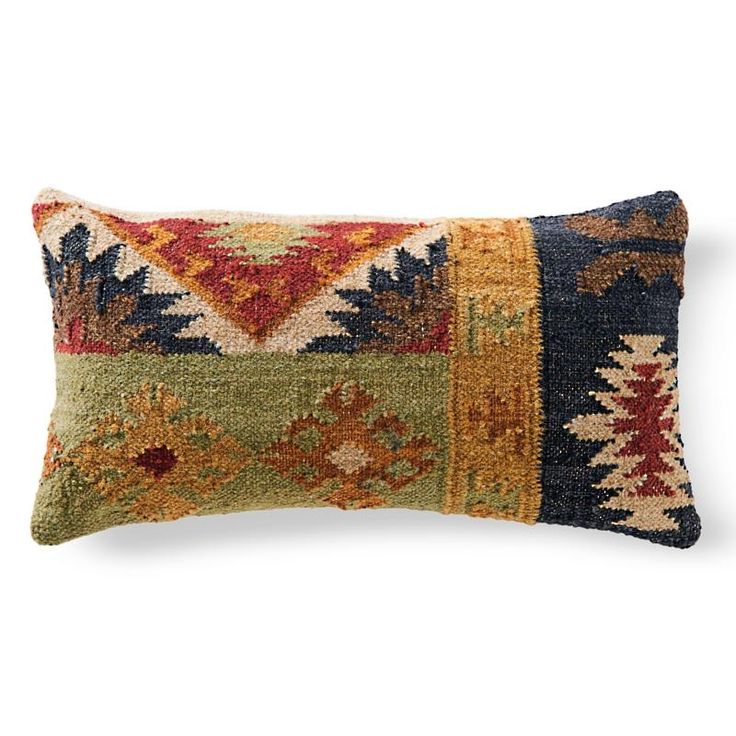 a decorative pillow with multicolored squares on the front and back, sitting on a white background