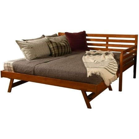 a bed that has pillows on it and is made out of wood with metal legs