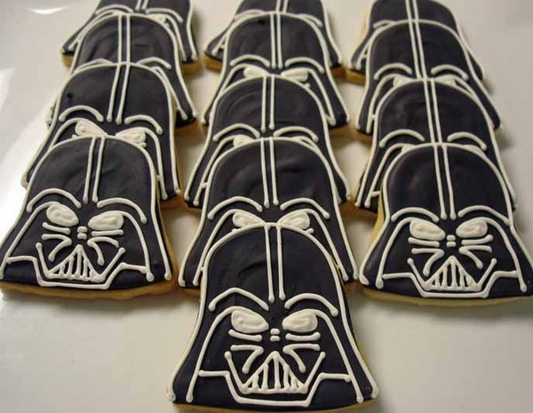 darth vader cookies decorated with royal icing on a white tablecloth, ready to be eaten