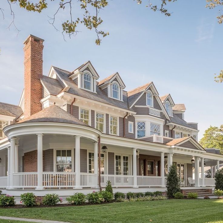 a large white house sitting on top of a lush green field