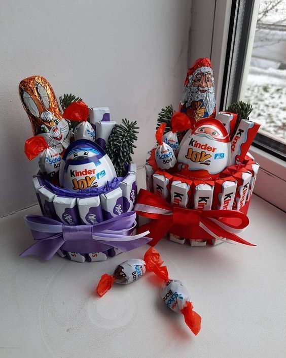 two baskets filled with candy sitting on top of a window sill next to a christmas tree