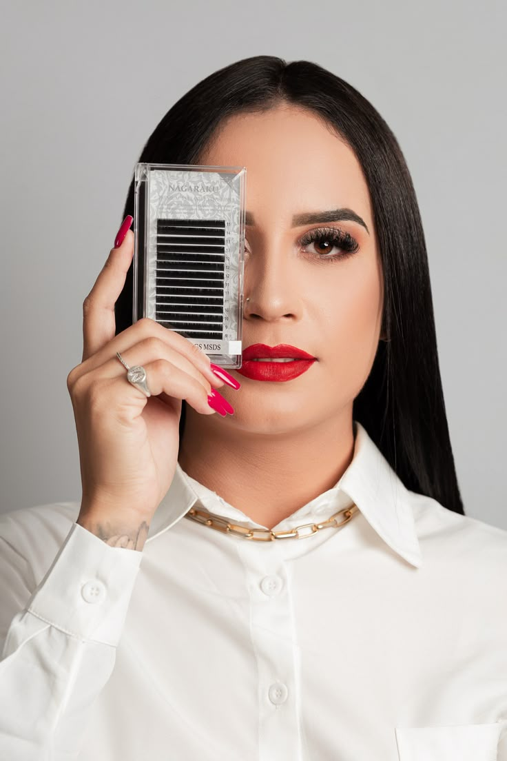 a woman holding an old fashioned camera up to her face