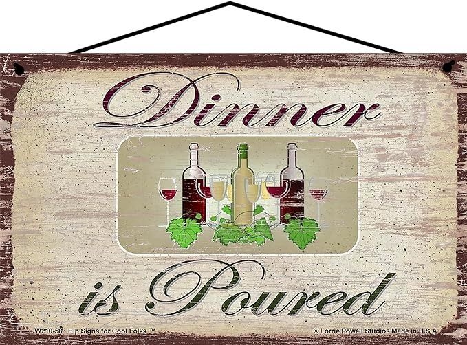 a wooden sign that says dinner is poured with wine bottles and green leaves on it