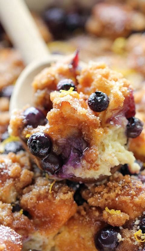 a spoon full of blueberry cobbler with crumbs