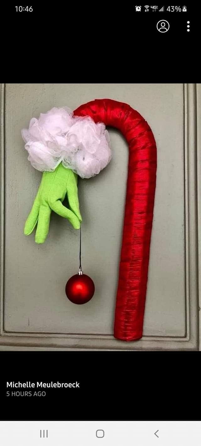 a hand that is hanging on the side of a door with a red ball attached to it