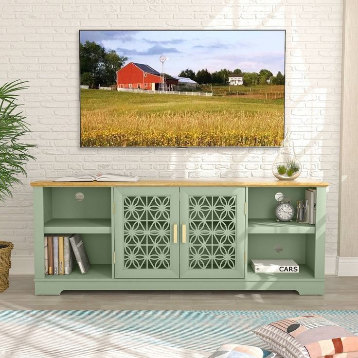 a living room scene with focus on the sideboard and red barn in the background