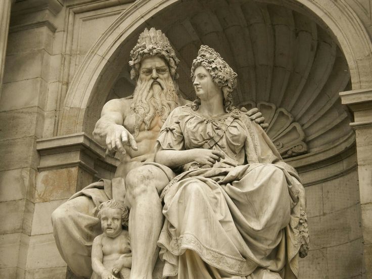 a statue of an old man with a beard sitting next to a child