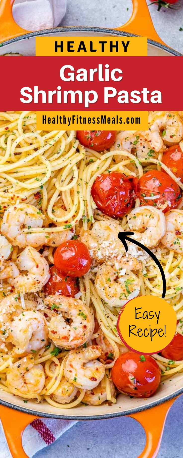 garlic shrimp pasta in a skillet with tomatoes and parmesan cheese