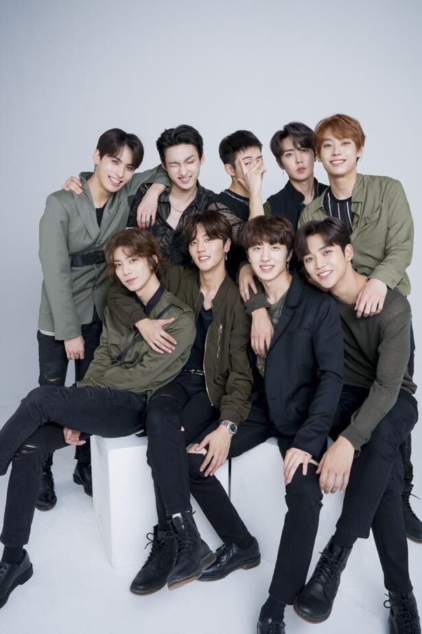 the group of young men are posing together for a photo in front of a white background