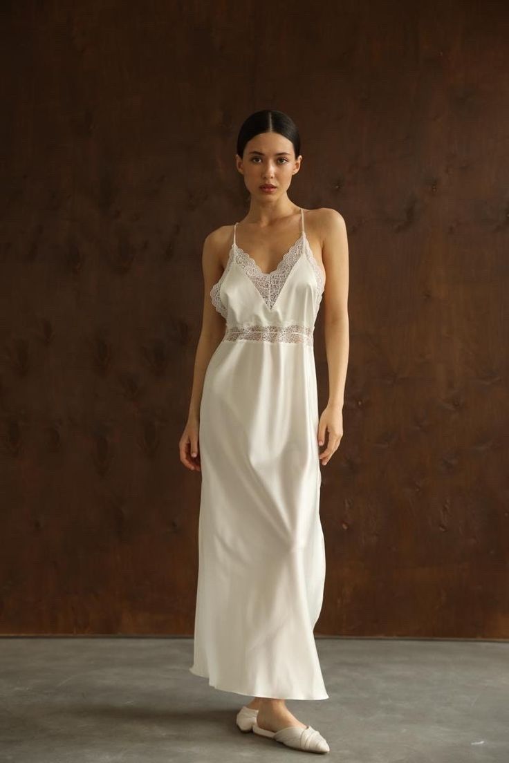 This long white Slip Dress made of soft pure mulberry silk. A V-neckline with lace, open back with adjustable spaghetti straps, meet a bias cut to fall beautifully against the body, inspiring a feminine silhouette. Effortless for both day and night, for romantic evening or as a bridal getting ready dress.   Model is 168 cm, 84/64/89 wears size XS Total length 135 cm from the shoulder  Off white color Luxury Sleeveless Feminine Slip Dress, Luxury Lined Bodice Slip Dress For Women, Luxury Romantic Maxi-length Slip Dress, Luxury Elegant Slip Dress With Lace Bodice, Luxury Fitted Slip Dress For Beach, Luxury Maxi Length Slip Dress With Lace Trim, Luxury Chic Slip Dress With Delicate Lace, Luxury Silk Slip Dress With Delicate Lace, Luxury Long Slip Dress