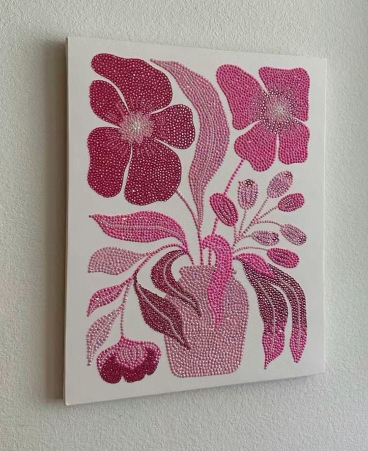 a white wall with a pink and red painting on it's side, featuring flowers in a vase