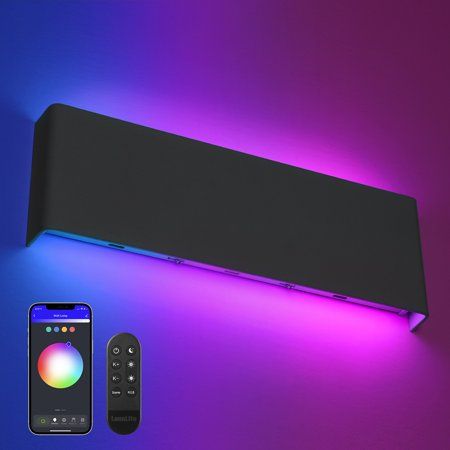 an electronic device is next to a remote control on a purple and blue background with lights