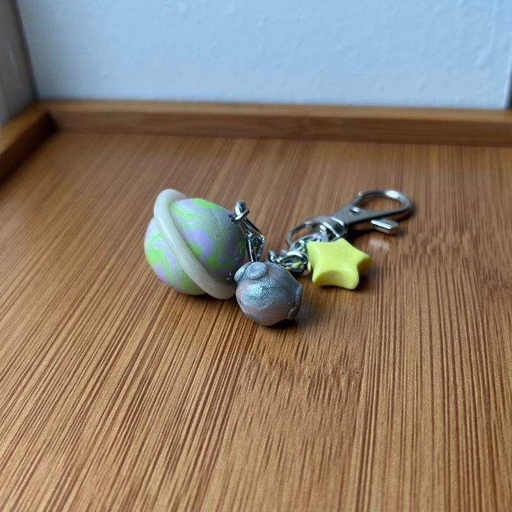 a pair of key chains sitting on top of a wooden table