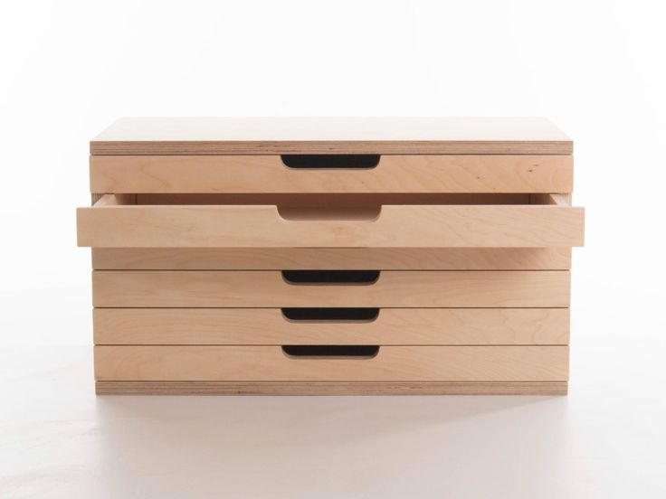 three wooden drawers sitting on top of each other