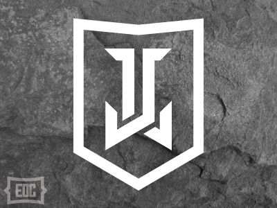 the u logo is shown on a stone wall with white lettering and an arrow in the middle