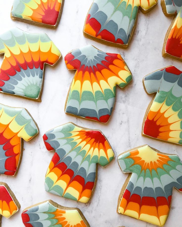 decorated cookies are arranged on a marble surface