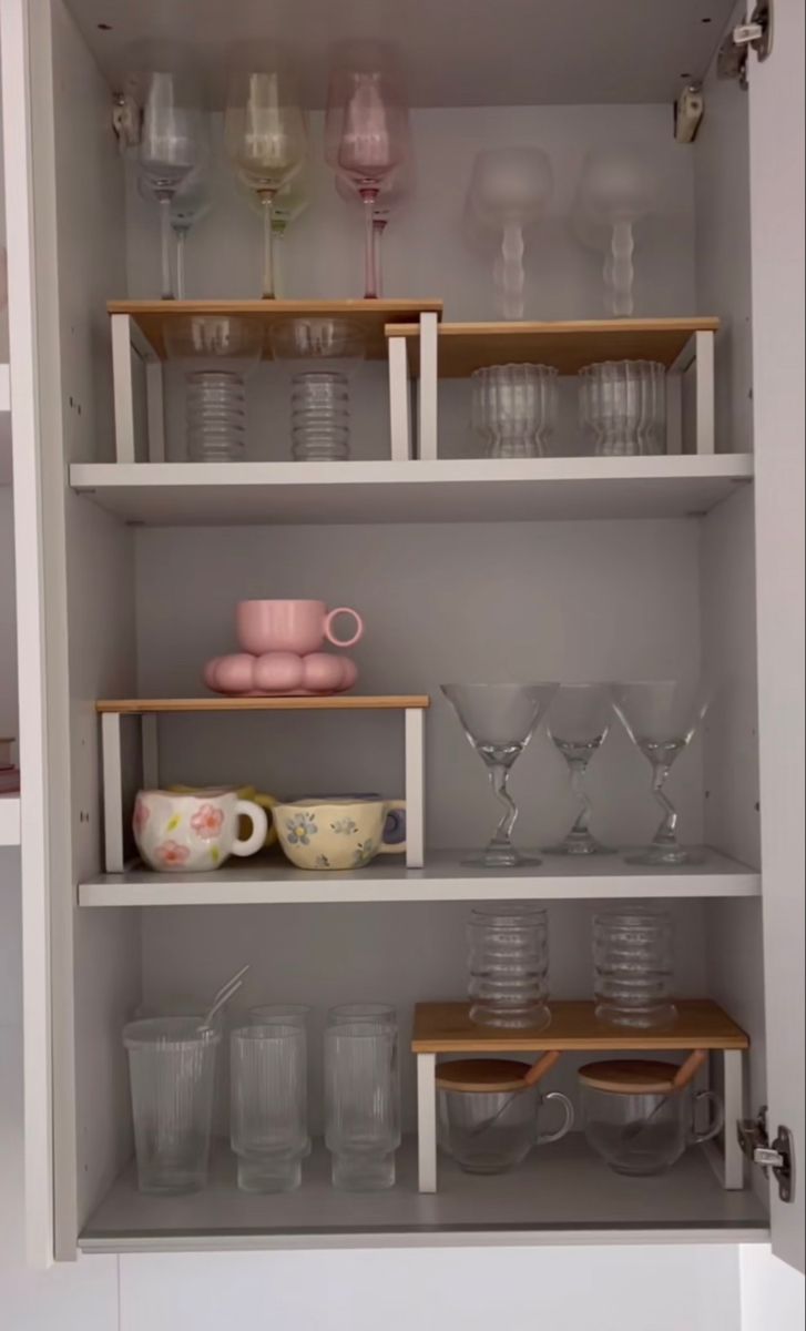 the shelves are filled with dishes and glasses