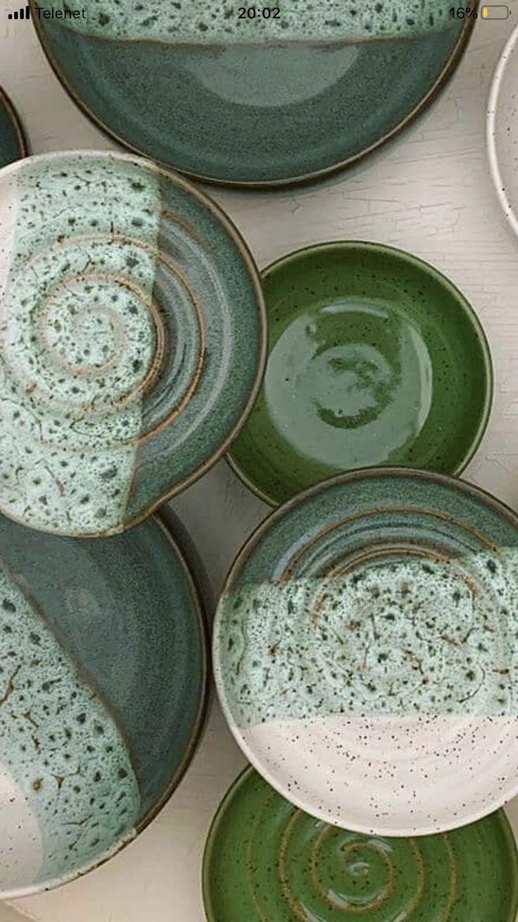 green and white plates stacked on top of each other in the shape of spirals