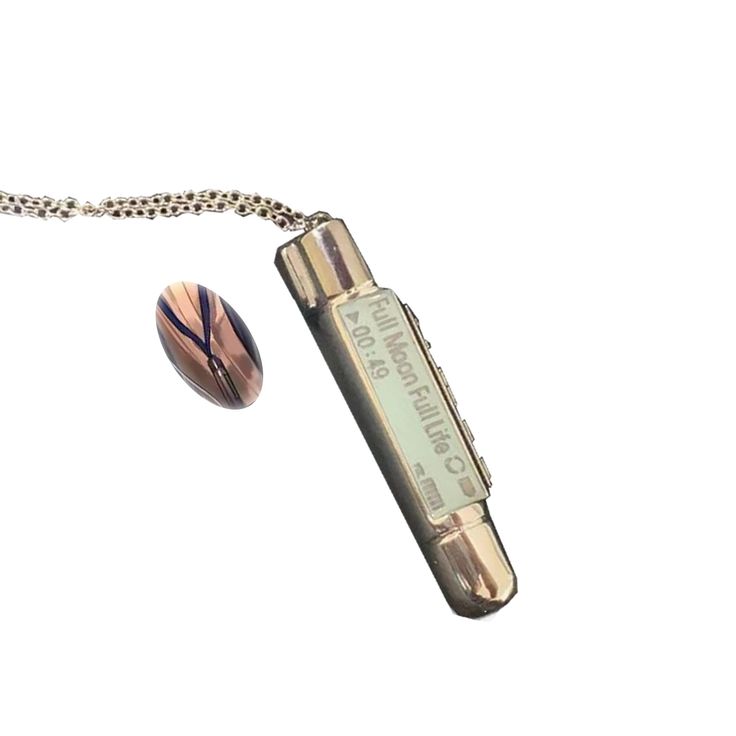 a lighter with a chain attached to it next to a ball on a white background