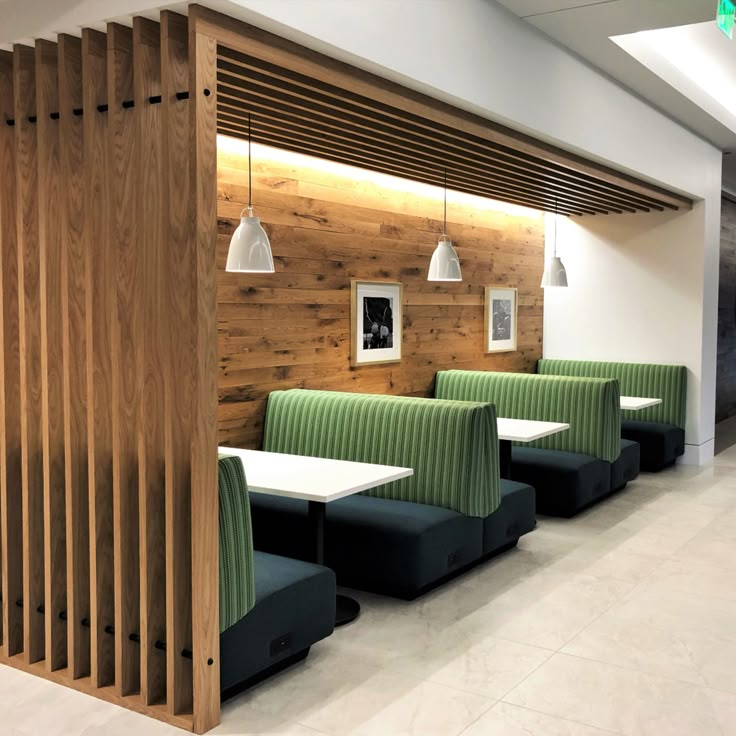 an empty restaurant with green and white booths