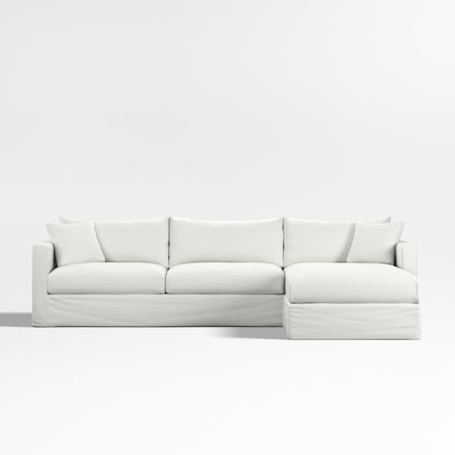 a white couch sitting on top of a white floor