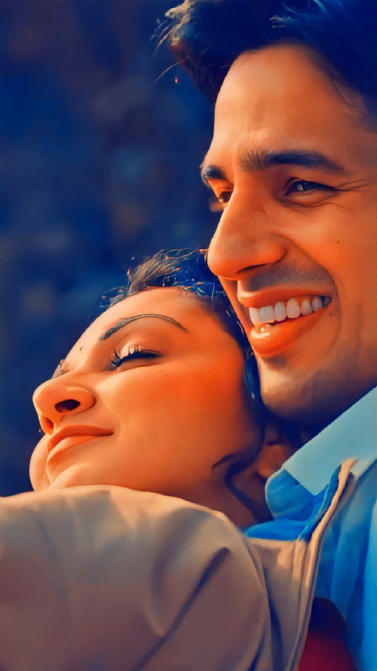 a man and woman are smiling at each other as they pose for a photo together