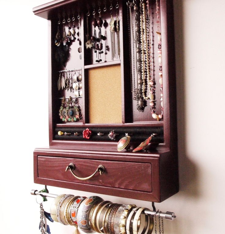 a wall mounted jewelry rack with many necklaces