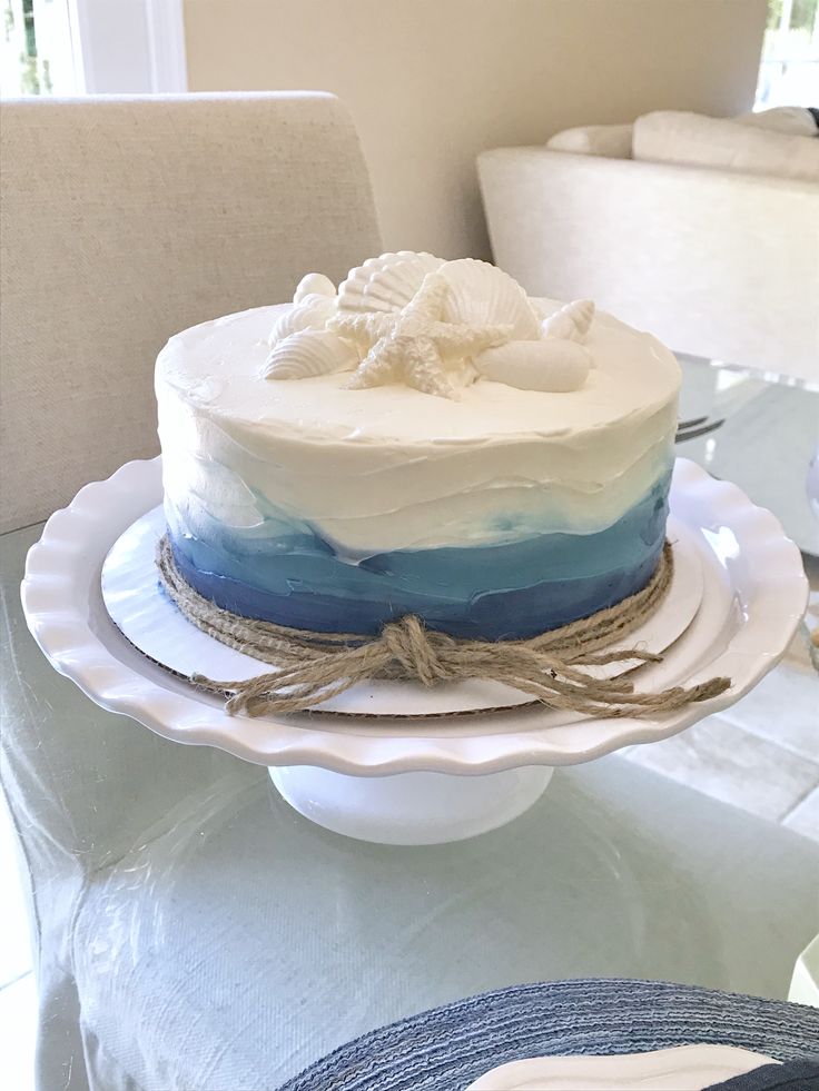 a blue and white cake sitting on top of a table