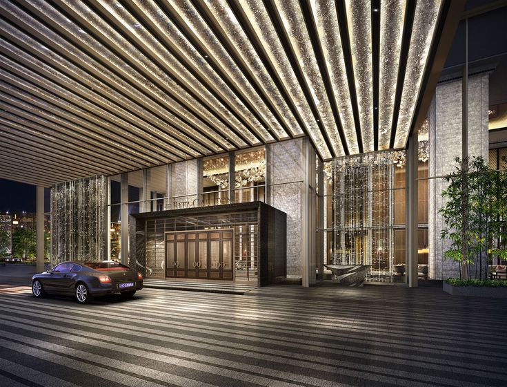 a car is parked in front of a building with lights on the outside and inside