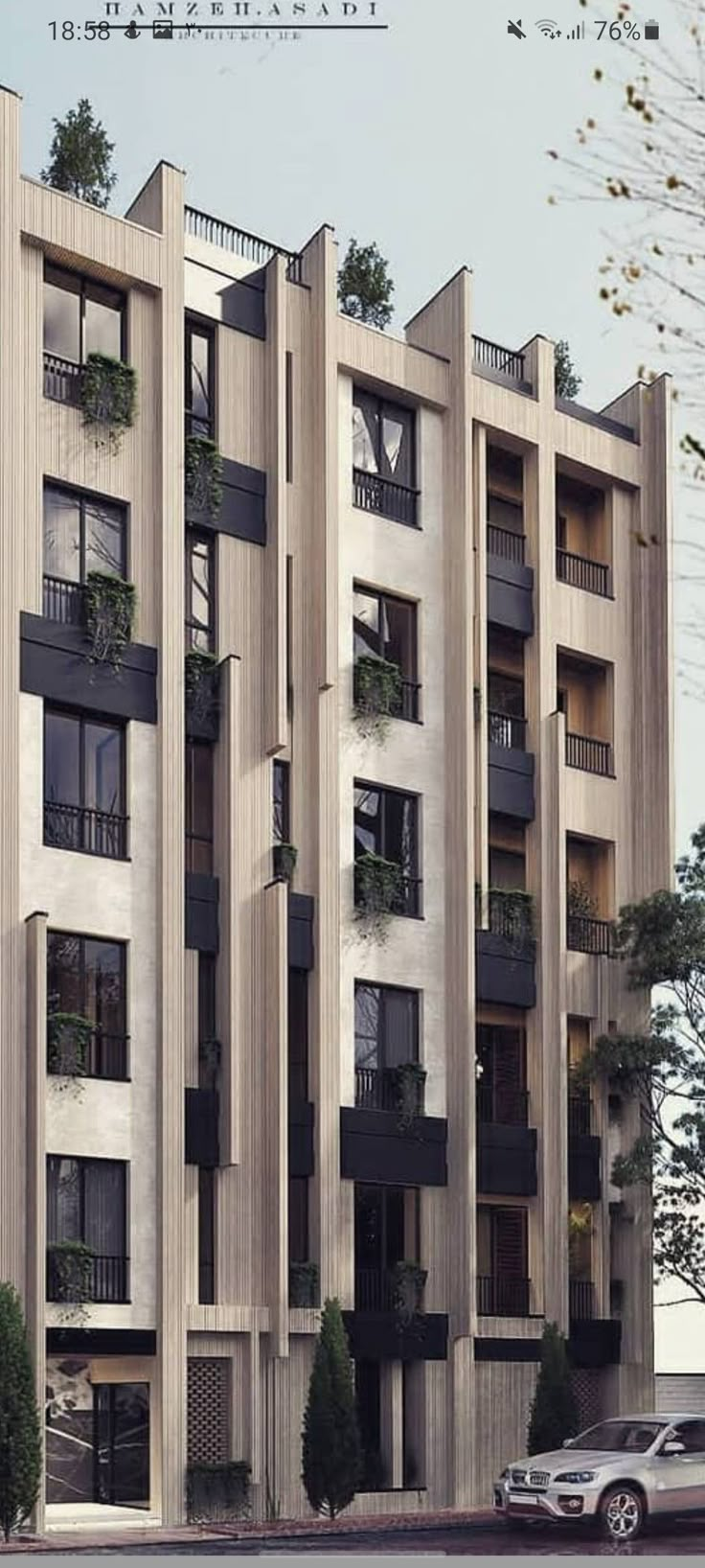 an apartment building with balconies and plants on the windows