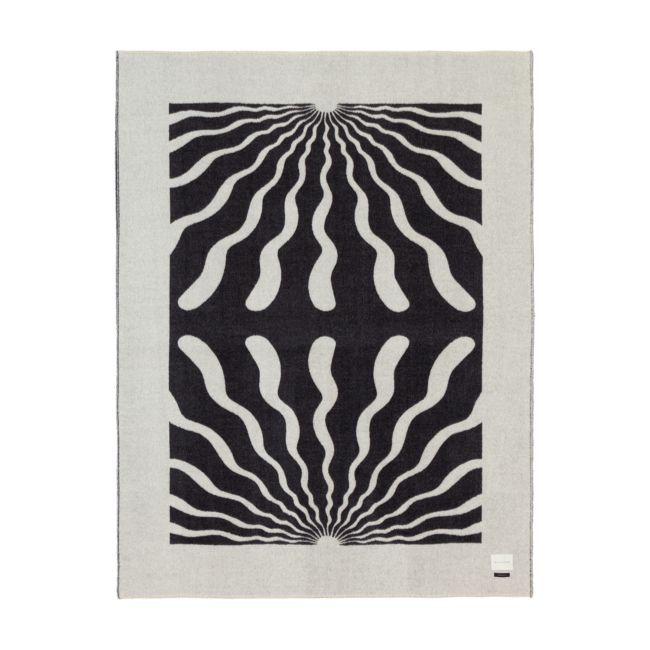 a black and white rug with an abstract design on the bottom, in front of a white background