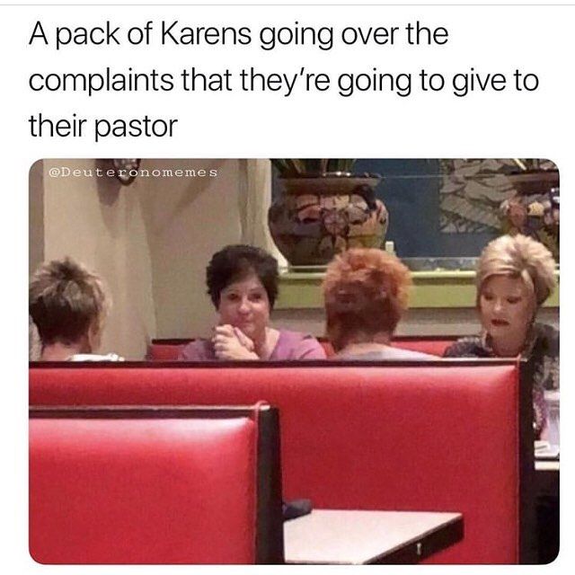 three women sitting at a table in a restaurant with one woman talking on the phone