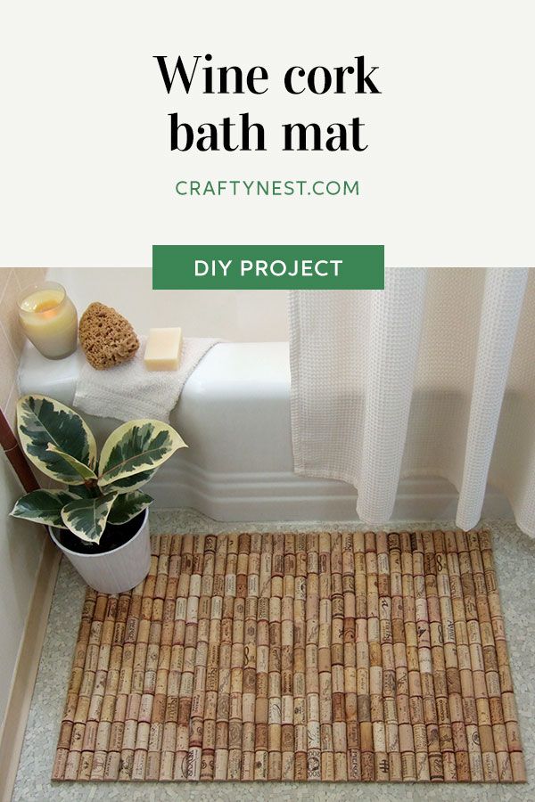 a bathroom with a bath mat on the floor and a potted plant next to it