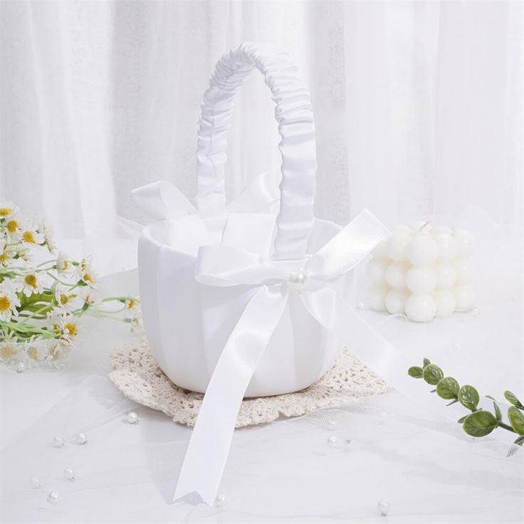 a white basket with a bow on it