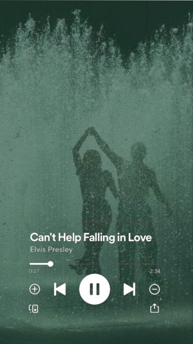 two people standing in front of a fountain with the words can't help falling in love