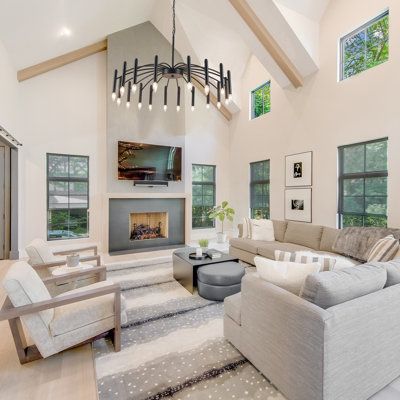 a living room filled with lots of furniture and a fire place in the middle of it