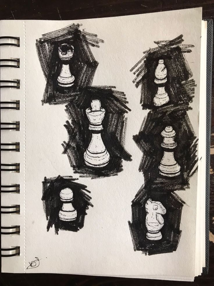 some black and white chess pieces are on a piece of paper that has been drawn