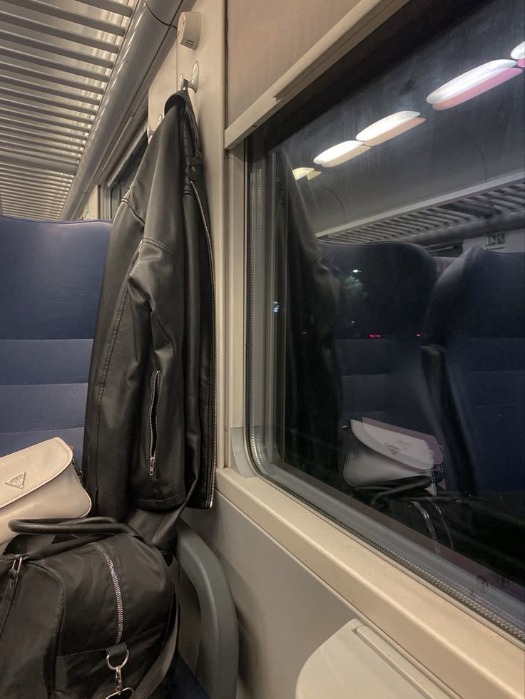 an empty seat on a train next to a backpack