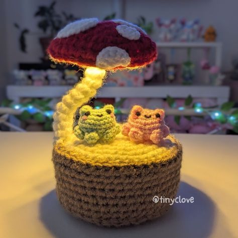 a crocheted basket with an owl and mushroom lamp on top, sitting on a table