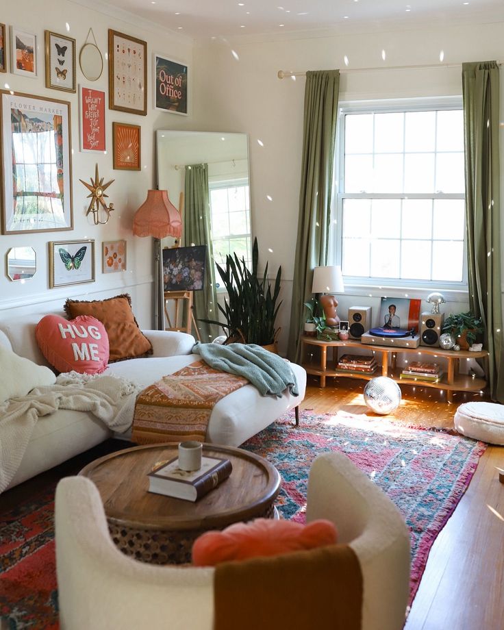 a living room filled with furniture and lots of pictures on the wall above it's windows