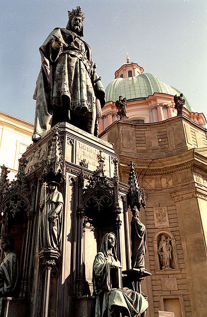 a statue in front of a large building