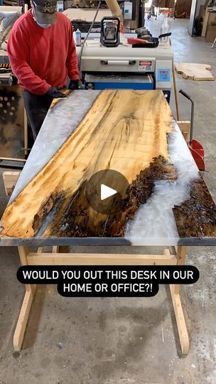 a man working on a piece of wood with the words would you out this desk in our home or office?