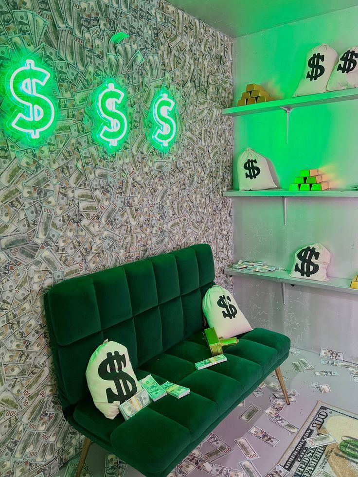 a green couch sitting in front of a wall with dollar signs on it and neon lights