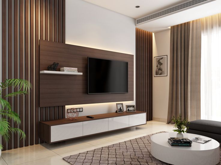 a living room with a large television on the wall