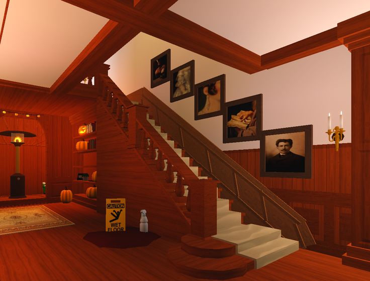 the stairs are made of wood and have pictures hanging on the wall next to them