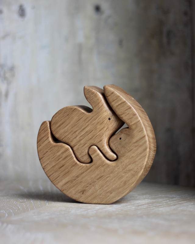 a wooden elephant figurine sitting on top of a table